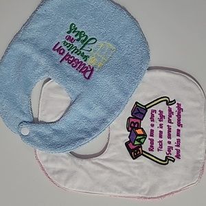 2 new Baby embroidered bibs never used